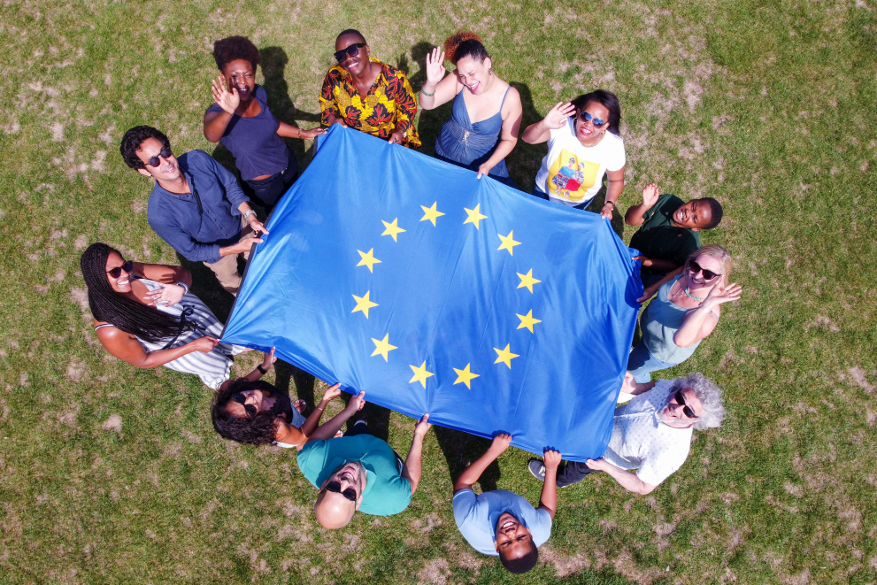 Aerial view of a group of people holding an EU flag